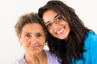 senior woman smiling with her caregiver
